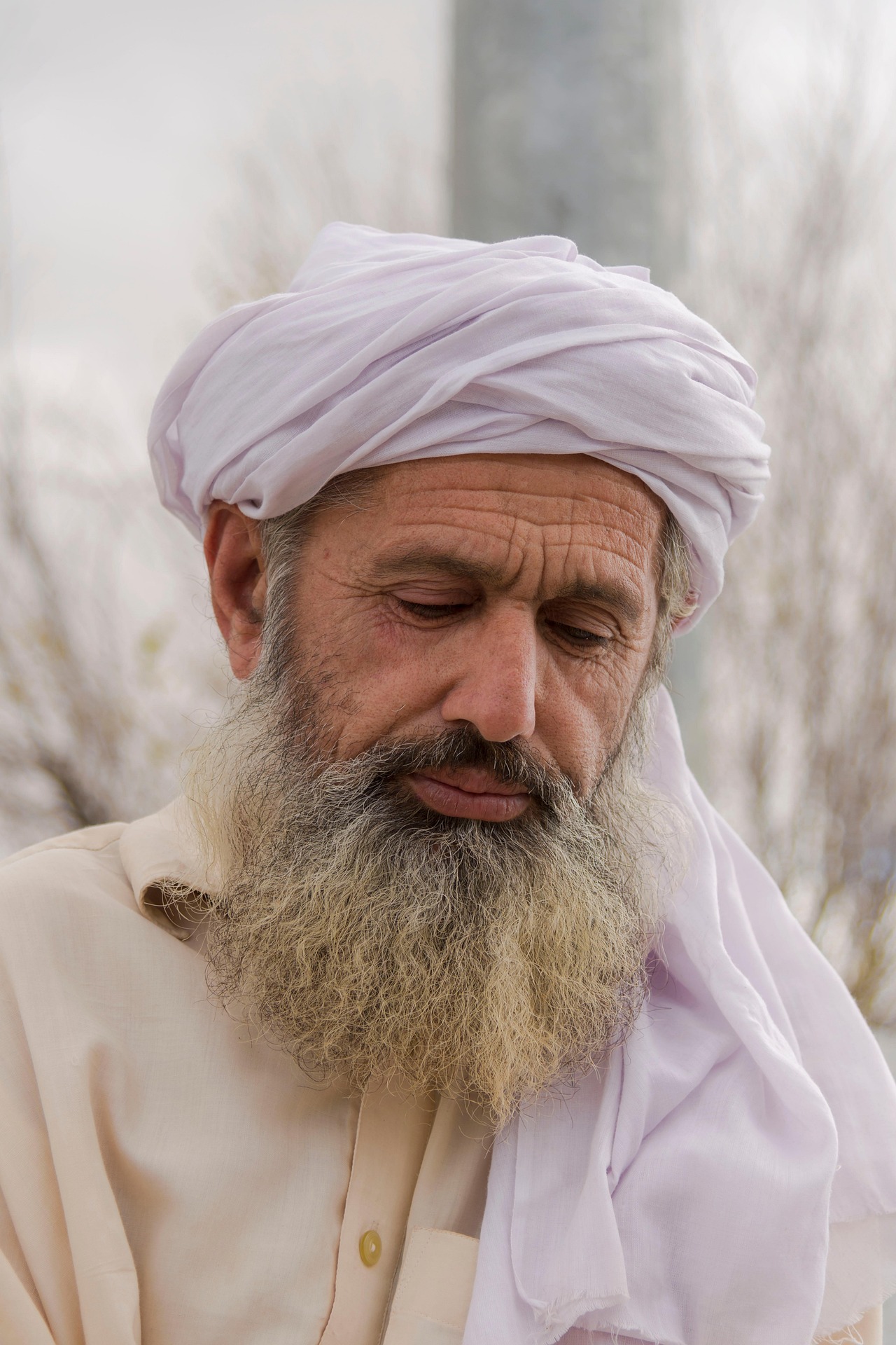 An elderly Muslim man reading